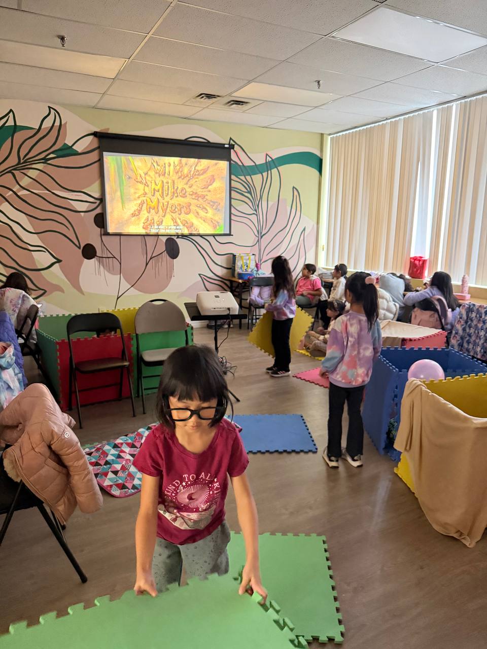 Campers watching a film on the projector during free time